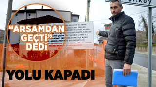 Arsasından geçirilen asfalt yolu duba ve filelerle kapattı