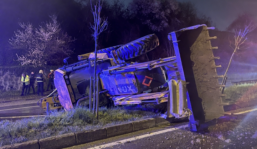 Bariyere çarpan iş makinesi refüje devrildi: 2 yaralı