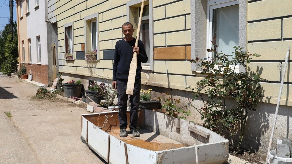 Taşkının yaşandığı mahallede ulaşımı kayıkla sağladı