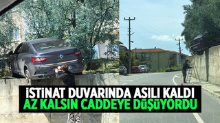 Otomobil istinat duvarında asılı kaldı