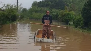 Taşkının yaşandığı mahallede ulaşımı kayıkla sağladı