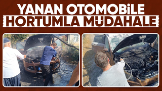 Yanan otomobili hortumla su tutarak söndürdüler